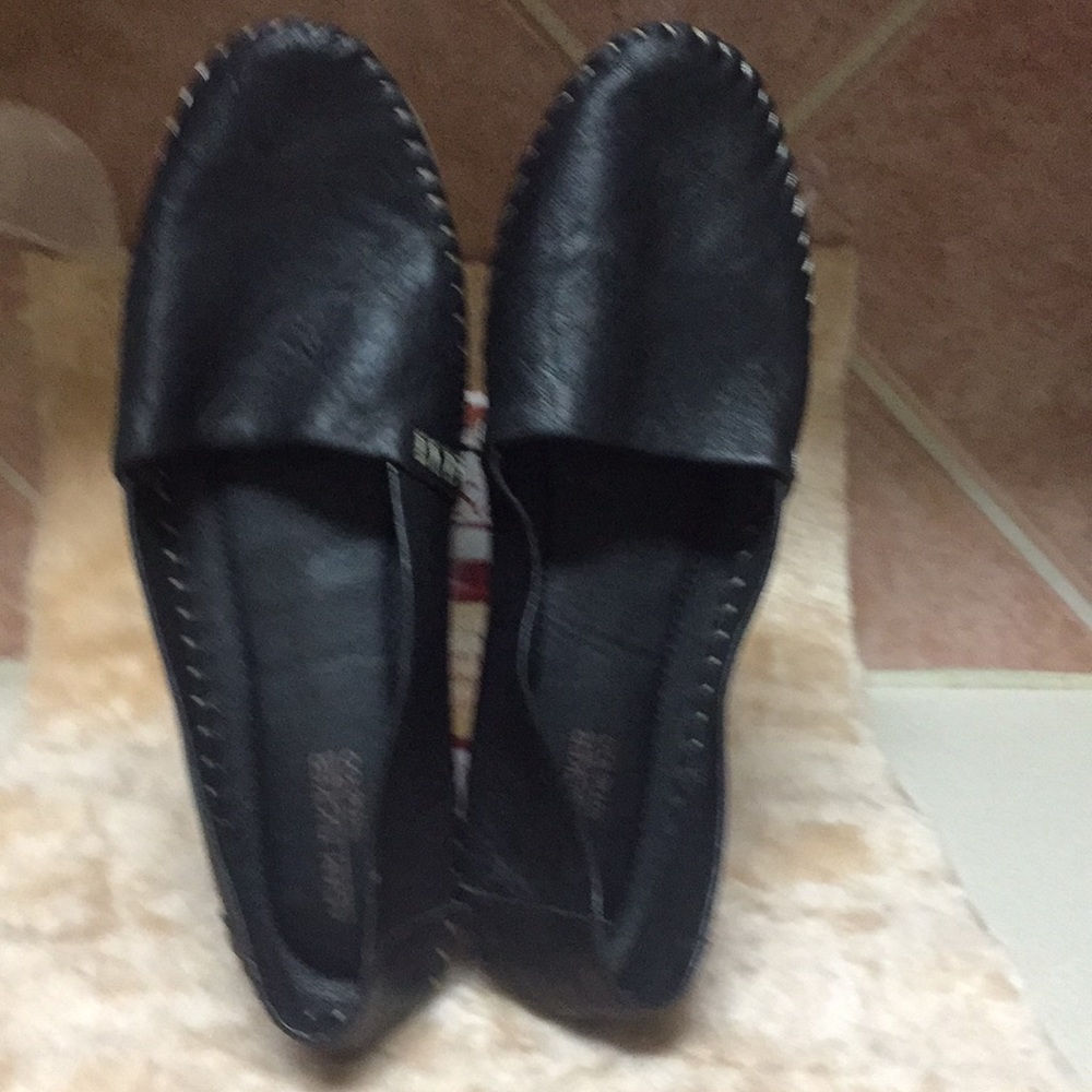 Black leather woman’s loafers.